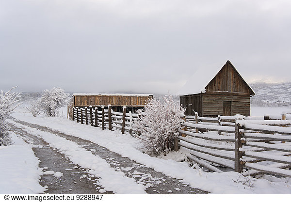 A barn and paddock with fencing in the snow in the Green River Lakes area.