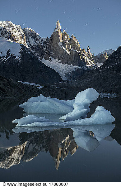 A big iceberg floats in Laguna Torre  with a perfect moonlit ref