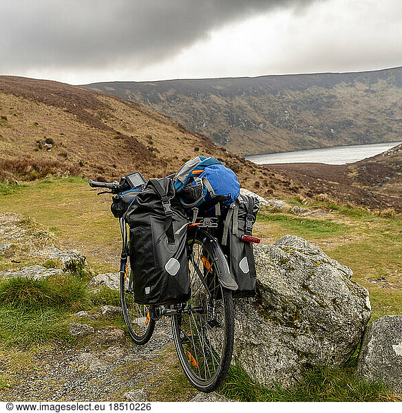 a Bike packer bike resting on mountainous landscape