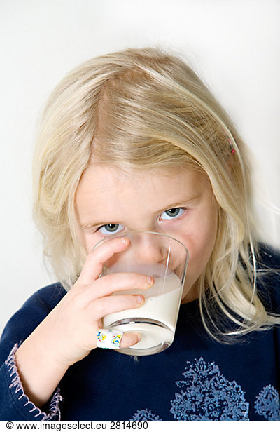 A blond Scandinavian girl drinking milk Sweden.
