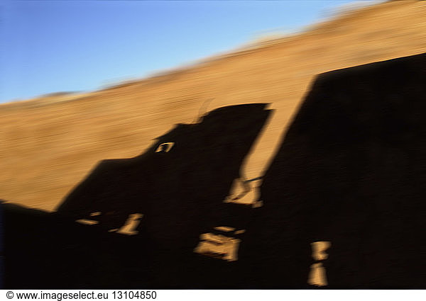 A blurred silhouette shadow on rock wall of a Class 8 sleeper truck