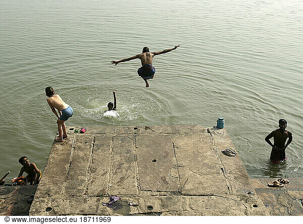 A boy dives into the river in the holy city of Varanasi (Benares) along the river Ganges  Uttar Pradesh  India.