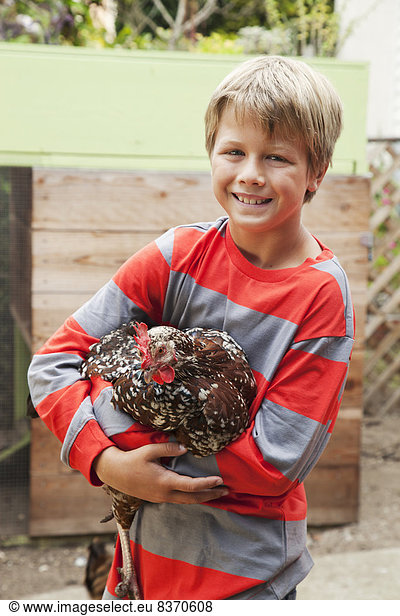 A Boy Holds A Chicken San Francisco  California  United States Of America