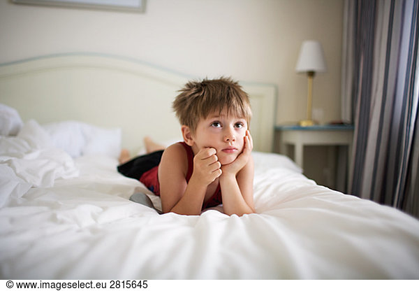 A boy lying in a bed Sweden.