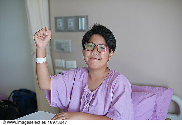 A boy patient with a strong heart smile ready to fight illness