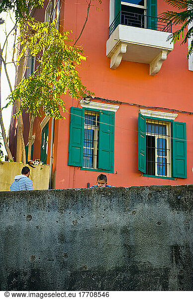 A Brightly Coloured Building With Green Shutters On The Windows; Beirut  Lebanon
