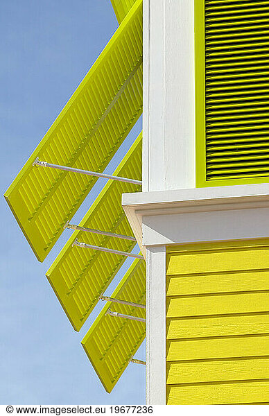A building in the Bahamas with colorful shutters.