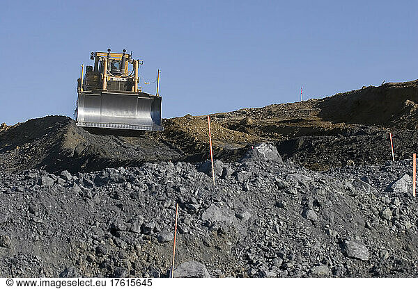 A bulldozer grading a new road.; Petaluma  California.