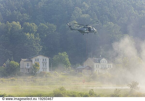 A Bundeswehr helicopter lands on the Elbe meadows in Bad Schandau on the Elbe  after a day of fire-fighting operations