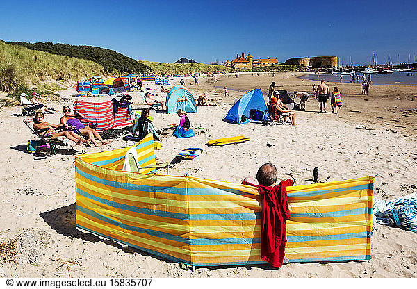 A busy summers day on Beadnell beach, Northumberland, UK.