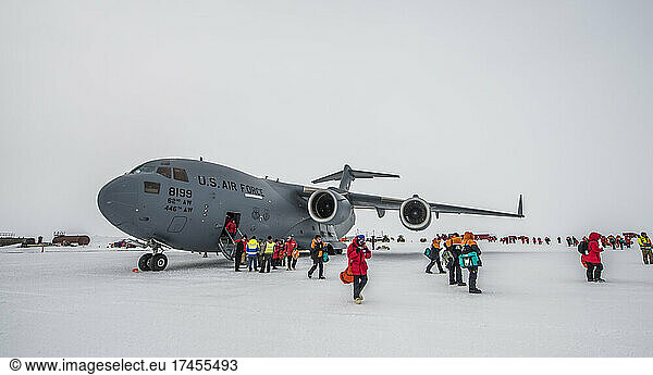 A c-17 cargo plane unloads on the ice runway of McMurdo Station