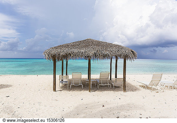 A cabana sun shelter on a sandy beach.