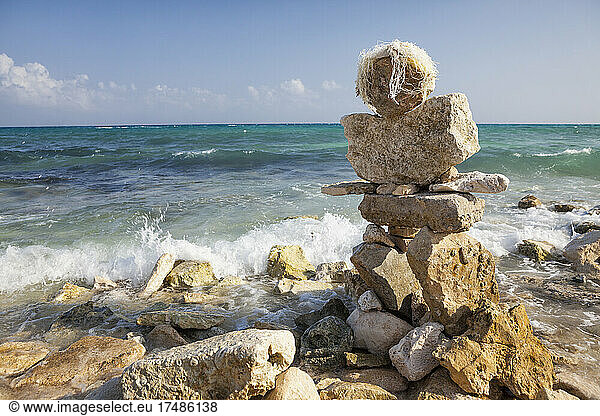 A cairn  pile of stones on the beach at the water's edge