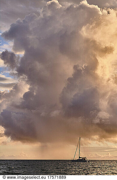 A catamaran is anchored off of Kamaole Beach during sunset in Kihea.