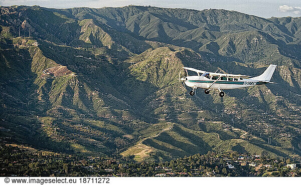 A Cessna 207 aircraft flies over Santa Barbara  California  in close plane to plane aerials.