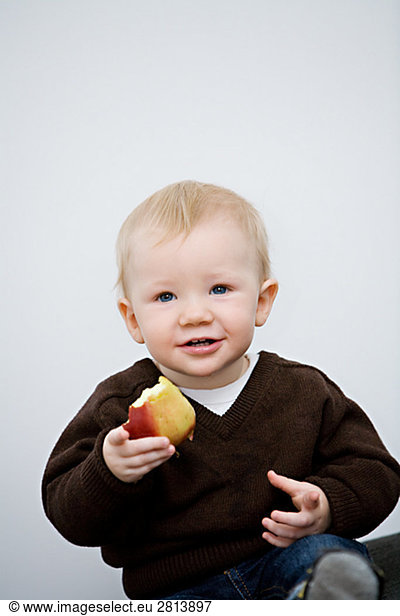 A child holding an apple Sweden.