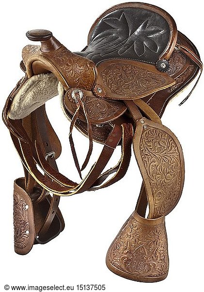 A children's Western saddle  20th century The underside with a leather construction  lined with fur  the saddle horn stamped with floral decorations and fenders on each side. The leather-covered stirrups attached. Elaborately worked and in near mint condition. Length circa 47 cm. historic  historical  accessory  accessories  miscellaneous  sundries  other  utility  utilities  equipment  utensil  piece of equipment  utensils  object  objects  stills  clipping  clippings  cut out  cut-out  cut-outs