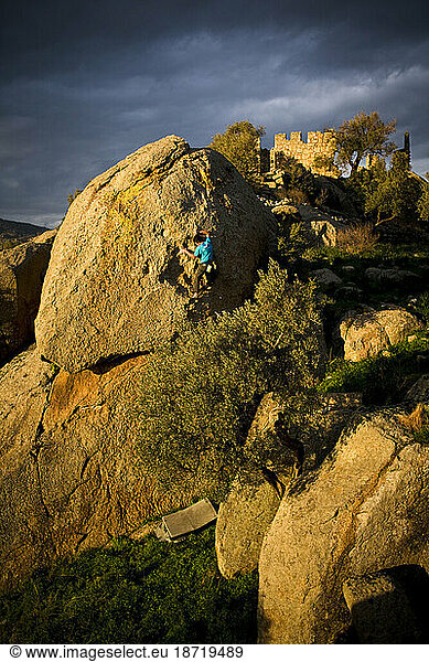 A climber boulders among the ancient ruins of Herakleia on the shore of Bafa Lake  Turkey.