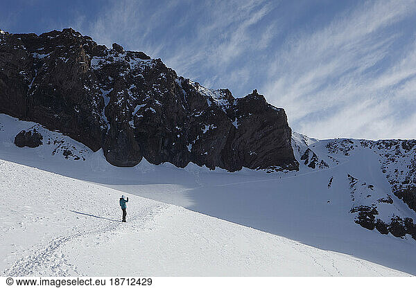 A Climber Pauses to Take Photos Above Mount Rainier's Camp Muir