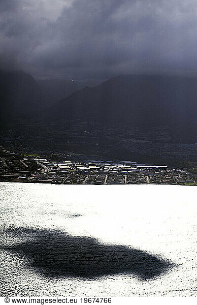 A cloud casts a shadow off the coast of Maui  Hawaii.