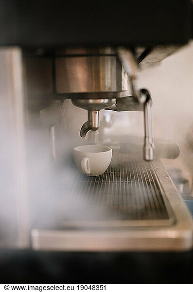A Coffee Machine Making Coffee. Steam from coffee machine