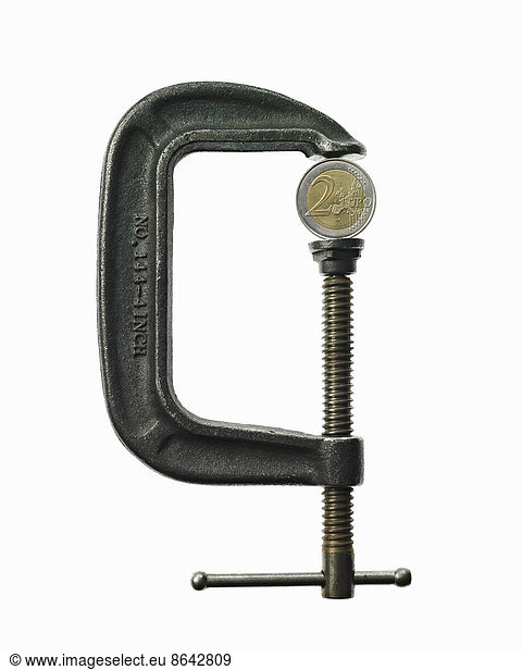 A coin in a clamp. Feeling the pinch  economic squeeze.