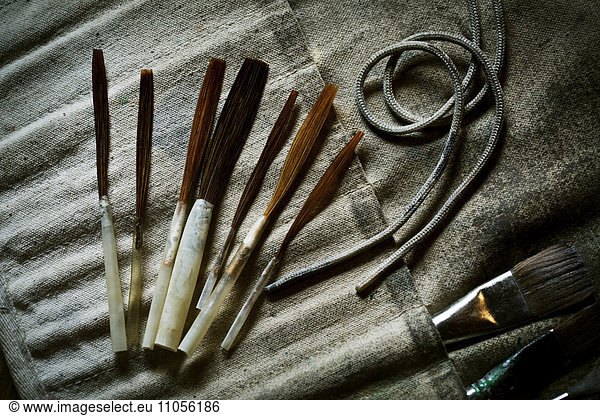 A collection of brushes and hand tools.