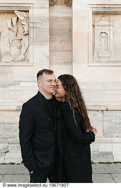 A couple in love hugging in the main square in Milan