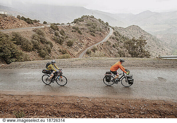 A couple of cyclists biking on the hairpin Tizi n Test pass  Morocco