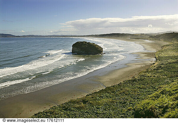 A deserted sandy bay open to Pacific surf Patagonia Chile.; Chiloe in Patagonia Chile.