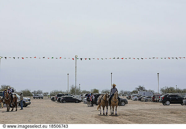 A dirt lot behind the Arizona Black Rodeo as participants gather