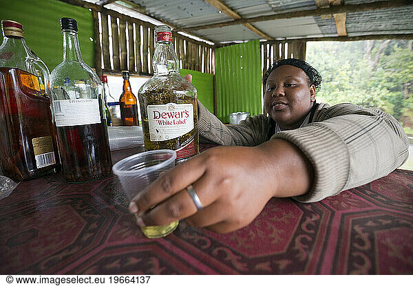 A Dominican woman serves a shot of local 'bush rum' (Dominican moonshine) infused with fresh local Anise. We discovered that this stuff is not to be trifled with.
