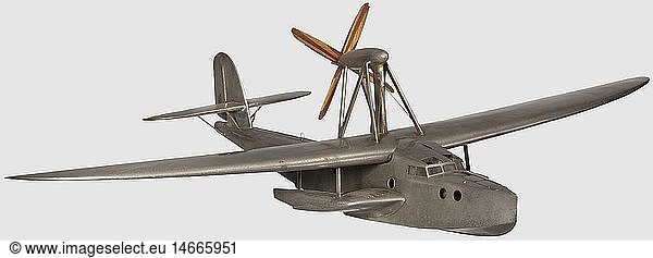 A Dornier Do 14  a rare model of the transocean experimental flying boat Nickel-plated brass static 1/20th scale model of this aircraft. The 90 cm long fuselage with nose mooring hatch with hinged cover  pennant socket  celluloid glazed cabin windows  sliding cover to crew entrance hatch  the two pilot's compartment or cabin with turn seats  control columns and rudder pedals  the engineers hinged hatch lifting to reveal a step ladder to the engine-room and cabin with sleeping-bunk  the two back-to-back dummy 690 HP BMW VI engines with transfer gearbox for the vertical drive shaft arranged to drive the four-blade 23 Â« cm diameter laminated oak and walnut propeller with aluminium spinner via an angular gear unit installed in the over-wing strut braced airship-pattern streamlined housing. Strut-braced tail plane  fin and rudder with some historic  historical  1930s  20th century  Air Force  branch of service  branches of service  armed service  armed services  military  militaria  air forces  object  objects  stills  clipping  clippings  cut out  cut-out  cut-outs  miniatures  miniature  mini  model-making  modelmaking  toy  toys  aeroplane  airplane  plane  airplanes  aeroplanes  planes  aircraft  aircraft  aviation  model aircraft  model plane  model aircraft  model planes
