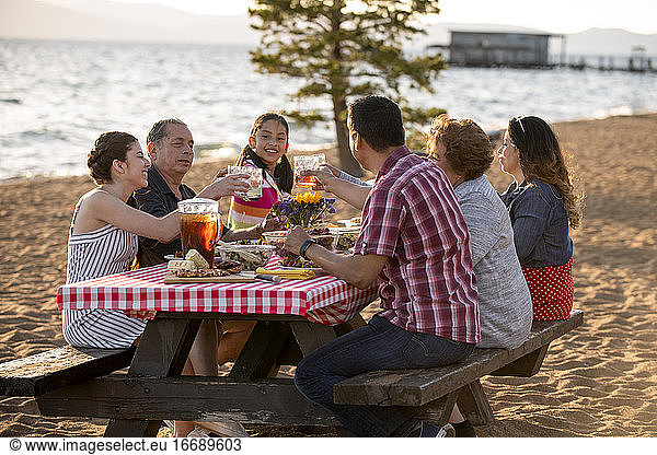 A family enjoys a beach BBQ on the shoreline of Lake Tahoe  NV