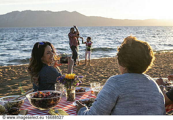 A family enjoys a beach picnic on the shoreline of Lake Tahoe  NV