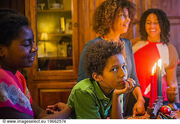 A family gathers around the Kwanza candles