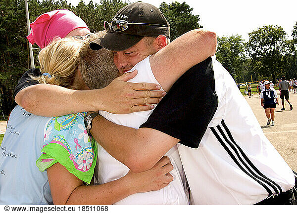 A family has a group hug after completing 60 miles in a breast cancer walk in Detroit.