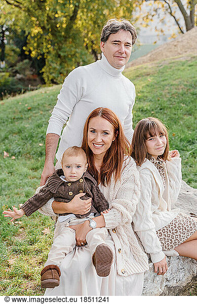 A family of four with a teenage girl and a toddler