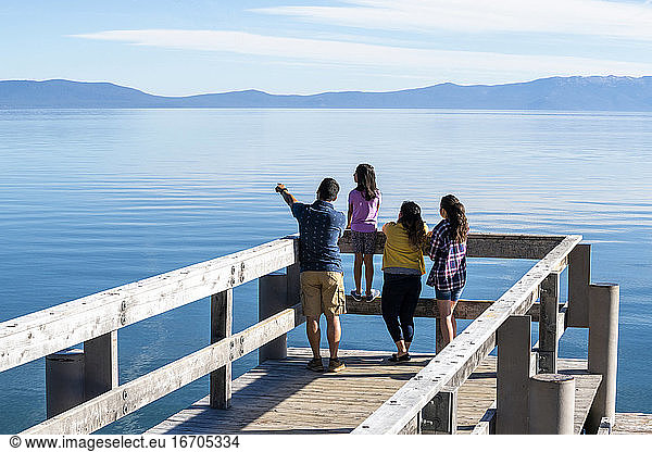 A family on a pier on a beautiful day in South Lake Tahoe  CA