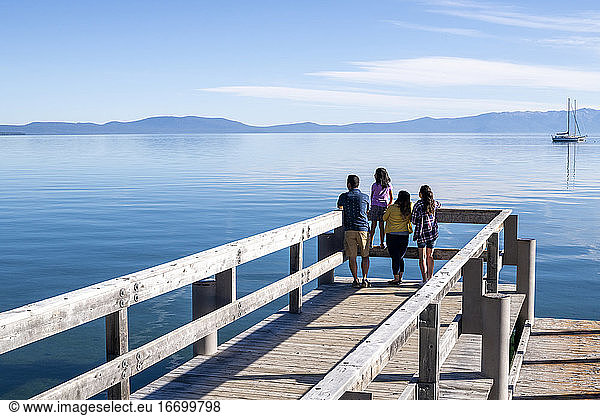 A family relaxes on a pier on a beautiful day in South Lake Tahoe  CA