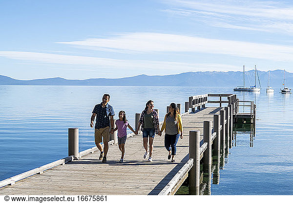 A family walks on a pier on a beautiful day in South Lake Tahoe  CA