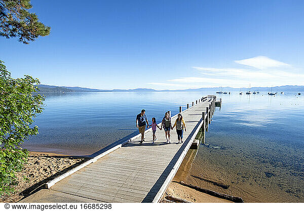A family walks on a pier on a beautiful day in South Lake Tahoe  CA