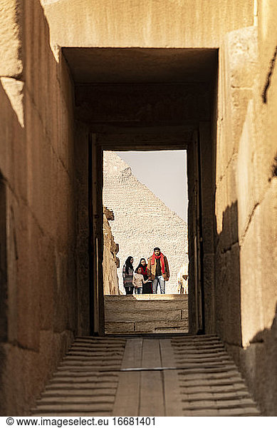 A family walks through the ruins of Giza  Egypt