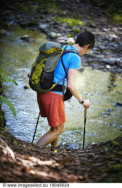 A female hikers using trekking poles.