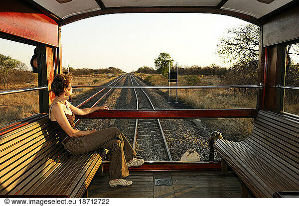 A female passenger enjoys the view from the Rovos Rail  Train  from Pretoria to Victoria Falls  Gauteng  South Africa