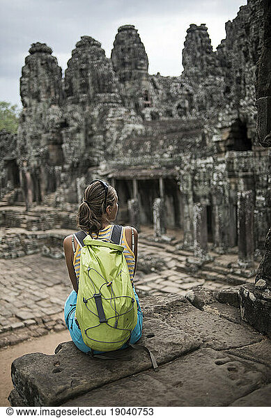 A female tourist at the Bayon  Ankor Thom temple  Angkor Wat  Siem Reap  Cambodia.