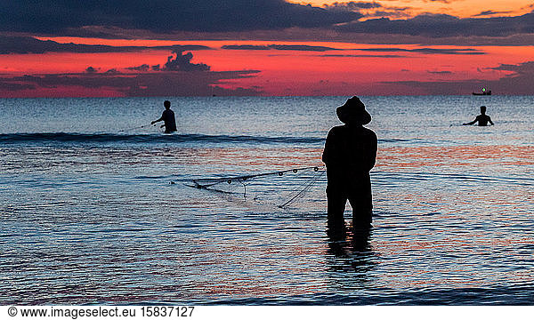 A fisherman is fishing at Sunset on Koh Rong  Cambodia