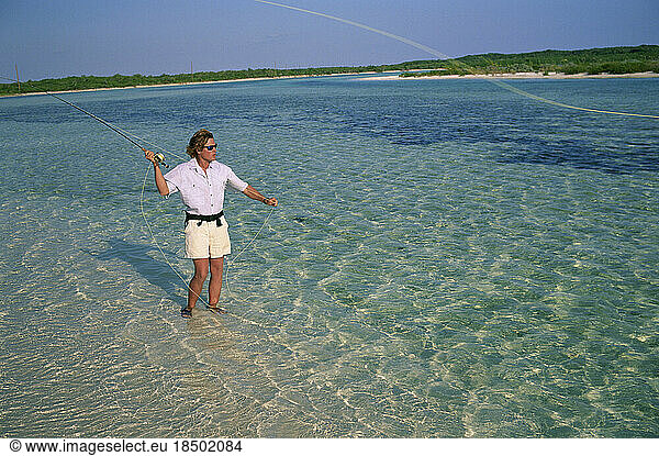A fly-fisherman casts to a bonefish in the Bahamas.