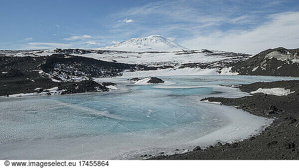 A frozen lake at Cape Royds  Antarctica with Mount Erebus behind