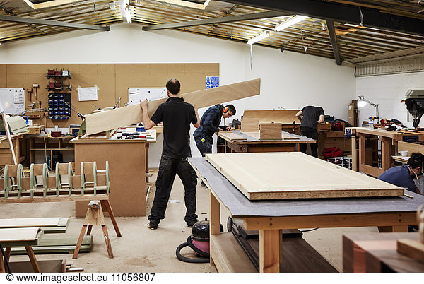 A furniture workshop making bespoke contemporary furniture pieces using traditional skills. Two men working with wood